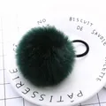 Close-up of soft dark green pompom hair tie with elastic band on white ceramic plate - Dark Green Pom Pom 5cm