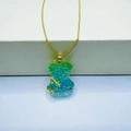 Golden necklace with blue and green crystal teddy bear pendant and star details - Necklace / Green