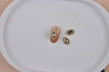 Oval gold alloy nail charms with crystal rhinestones on a beige ceramic tray - Gold Border Tawny Oval Accessory