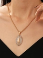 Detail of rugby pendant necklace with rhinestones on model neck showing gold chain texture - Alloy Rhinestone Rugby Football Necklace (X584)