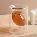 Rugby-shaped double wall glass shot glass filled with amber liquid on a wooden base - Rugby Double Layer Cup/30ml-60ml