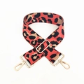 Detail of adjustable leopard print bag strap with red accents and gold hardware - Orange Red