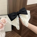 Close-up of large lace bow hair claw clip with black satin and white mesh texture - Lace Bow Ponytail Clip / Black & Beige