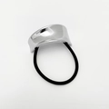 Macro shot of silver curved zinc alloy ornament on a black elastic punk hair tie - Plain Silver