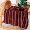 Muslin cotton baby blanket in deep burgundy with white arrow pattern on wooden cradle - Deep Reddish Brown Chevron
