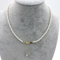 Detail view of round white pearl necklace with adjustable gold-plated lobster clasp - 18K Gold Plated 2mm (38+4cm)