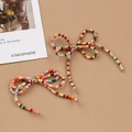 Accessorio fiocco di perline colorate fatto a mano con perle metalliche su sfondo beige - Stile multicolore (U-57)