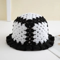 Detail of handmade crochet bucket hat with black and white knit floral patterns - One Size / Black & White