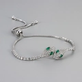Luxurious silver snake head bolo bracelet with sparkling white diamonds and green eyes - White Gold with Green Eyes