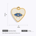 Macro detail of 18k gold plated stainless steel heart charm with evil eye enamel - Blue Evil Eye Heart