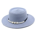 Dettaglio del cappello di paglia blu con nastro nero ed eleganti decorazioni di perle - Celeste
