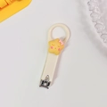 Cute beige nail clipper with a yellow cartoon star character and pink bow design - Beige Star