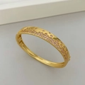 Vue macro d'un bracelet doré avec un pavage de zircons roses et violets étincelants - Or Zircone Rose