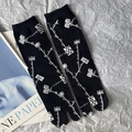 Japanese style black tabi socks with white geometric patterns displayed on a magazine - 35-41 / Black Link