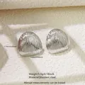 Detailed view of silver stainless steel triangle earrings with vertical stripe texture - Striped Triangle