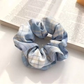 Blue and white plaid fabric scrunchie with soft pleats on a vintage book background - Ice Cream Blue
