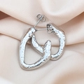 Macro shot of silver textured hollow earrings on elegant champagne silk fabric - Dot / Silver