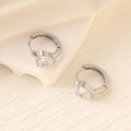 Close-up of silver earrings featuring heart-shaped cubic zirconia on geometric stands - Silver (Pear/Heart)