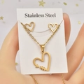Macro detail of golden stainless steel heart and arrow necklace with matching stud earrings - Heart with Arrow Tip / Gold