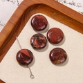 Five round red jasper beads with natural black veins on a rustic wooden tray - Reddish Brown Black Veined Round Flat Style (31号)