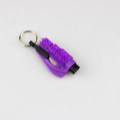 Detail of purple emergency tool with crystal trim and metallic keyring on white background - Purple