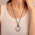 Minimalist silver spiral pendant necklace with a black cord on a model wearing white - 14# Silver Metal Swirl Sweater Necklace