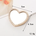 Detail view of heart-shaped gold mirror with inlaid rhinestones and 5cm x 4.5cm dimensions - Gold Small Heart (5cm)
