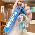 Blue liquid quicksand astronaut keychain with Dream On strap and glittery star sequins - Ocean Astronaut-Standing Yellow Face