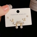Detailed close-up of a 3-piece gold earring set with studs, butterflies, and pearls - Gold-Rhinestone Bowknot Pearl Set (52#)
