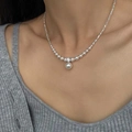 Elegant beaded pearl necklace with silver accents and central pendant worn on neck - Artificial Pearl Silver Chip Necklace (X2979) / Silver