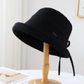 Detail view of black cotton bucket hat featuring a Hand Made metal label and back ribbon tie - M (56-58cm) / Black