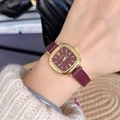 Square gold watch with deep red dial and red leather strap worn by a model - Style 23059