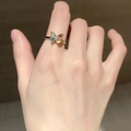 Adjustable gold butterfly ring with colorful gemstone wings worn on a finger - Colored Gem Butterfly
