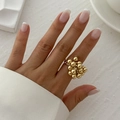Close-up of a gold-toned beaded ring with a cluster-like design on a model's finger - One Size (Adjustable Open) / Light Gold (0762 Bead Cluster)