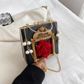 Vintage black clutch featuring golden frame, bow decoration, and pearl chain handle - Flower Black