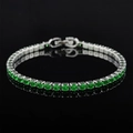 Macro shot of silver tennis bracelet with round cut green emerald zircons and fold-over clasp - 3mm-17cm / Green Zirconia