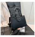 Detail of black crocodile texture patchwork on a stylish square handbag for women - Black