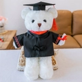 Plush white graduation teddy bear wearing black gown and doctoral cap with red tassel - White Braided Graduation Bear - Red Collar / 30 cm