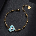 Detailed close-up of gold stainless steel bracelet with blue enamel evil eye heart charm - Style 12 (Light Blue Heart)