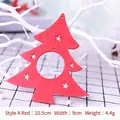 Red Christmas tree wooden pendant with star cutouts hanging on a white branch - Red Christmas Tree Ornament