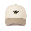 Close-up of a two-tone trucker cap featuring a detailed yellow and black bee embroidery - Khaki