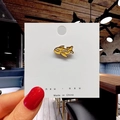 Close-up of a cute yellow plane enamel pin on cardstock with a cozy cafe background - 5*Yellow Airship Pin