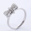 Elegant silver bow ring for women with sparkling white crystals on a white background - US 6 / Steel