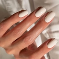 Close-up of elegant medium-length milky white square press-on nails on a hand - Medium Square / Warm White