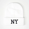 Close-up of black NY letter embroidery on a white ribbed knit beanie hat - One Size / White
