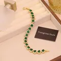 Detail of luxury heart emerald bracelet with 18K gold plating and cubic zirconia - Green