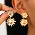 Elegant gold sunflower earrings with a multi-layered petal design on a model's hand - Sunflower Shape Pendant Style (11911) / Gold