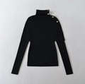 Detailed view of black ribbed knit sweater with decorative gold buttons on the collar - One Size / Black