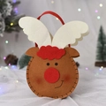 Close-up of reindeer felt Christmas gift bag with festive bokeh lights background - Q Edition Reindeer