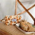 Detail of floral corduroy makeup bag with orange flowers and soft side handle - Beige Tulip